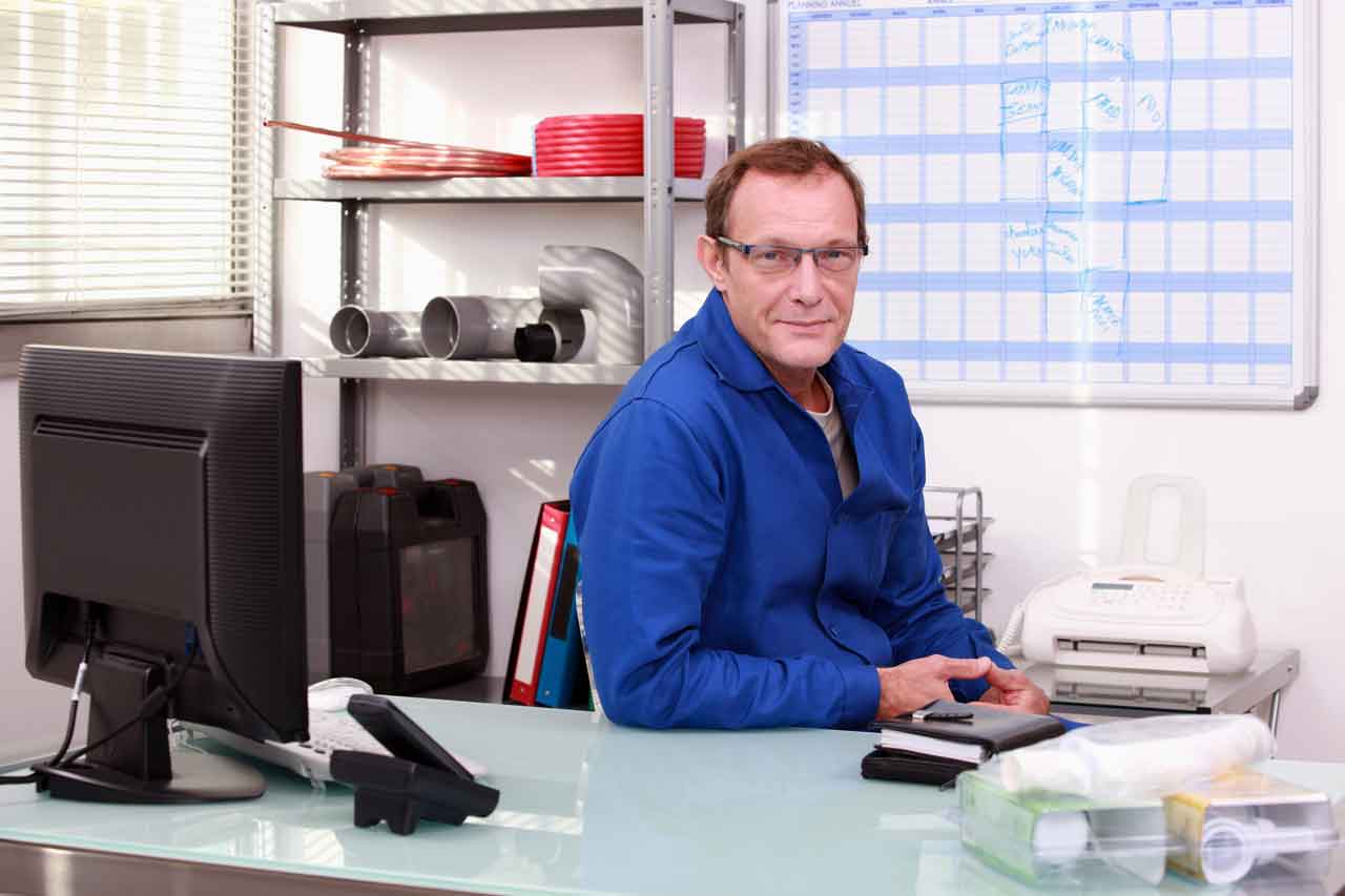 6F feature image of plumber sitting in clear office